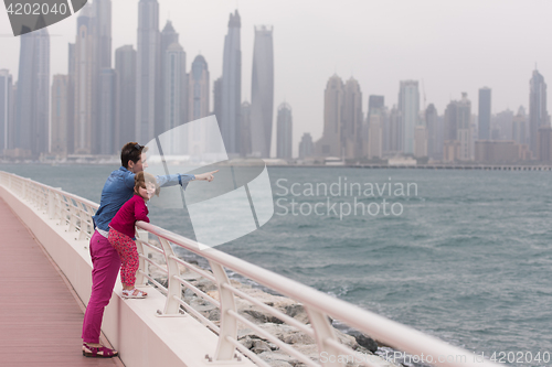 Image of mother and cute little girl on the promenade