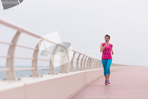 Image of woman busy running on the promenade