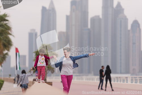 Image of mother and cute little girl on the promenade