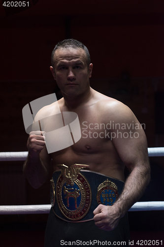 Image of kick boxer with his championship belt