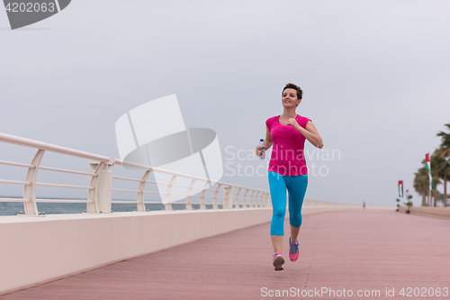 Image of woman busy running on the promenade