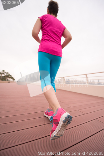 Image of woman running on the promenade