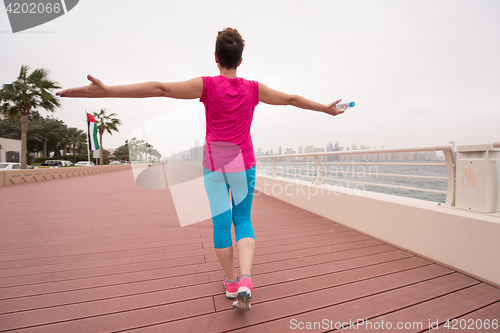 Image of young woman celebrating a successful training run