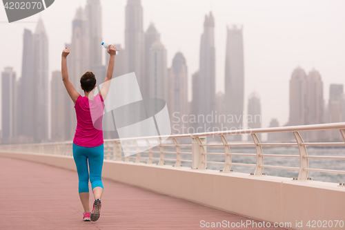 Image of young woman celebrating a successful training run