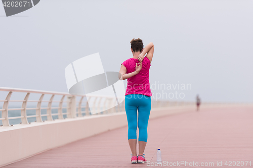 Image of woman stretching and warming up on the promenade