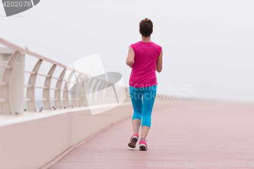 Image of woman busy running on the promenade