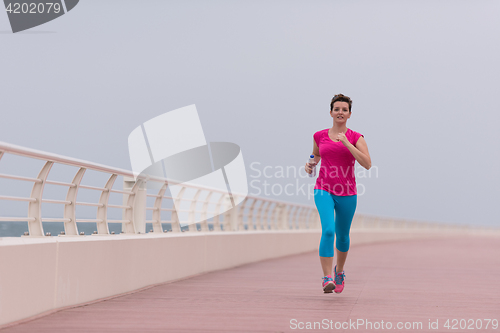 Image of woman busy running on the promenade