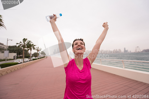 Image of young woman celebrating a successful training run