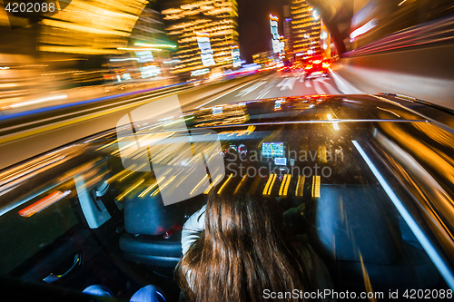 Image of Passenger car driving through a city