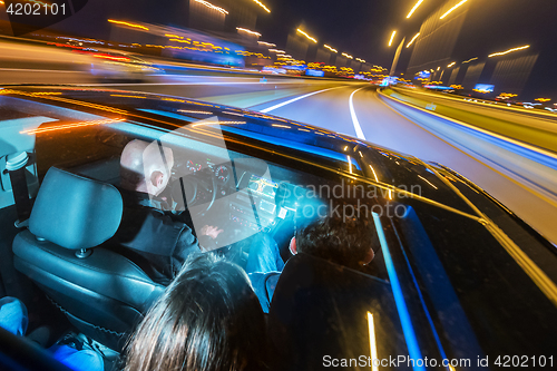 Image of Car pooling at night