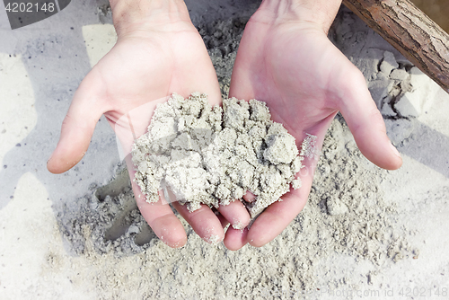 Image of White Quartz Sand In The Hands