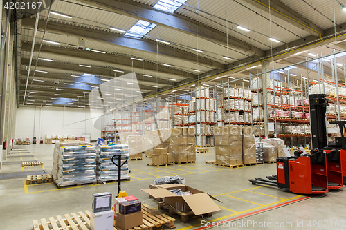 Image of forklift loader and cargo boxes at warehouse