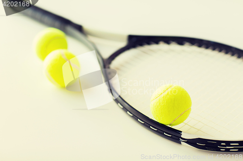 Image of close up of tennis racket with balls