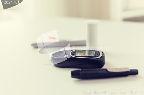 Image of close up of glucometer and blood sugar test stick