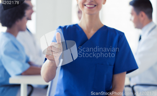 Image of close up of doctor showing thumbs at hospital