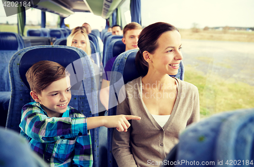 Image of happy family riding in travel bus