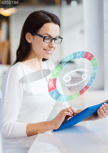 Image of woman with tablet pc and zodiac signs at cafe