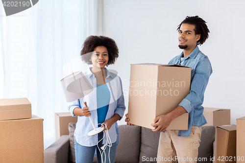 Image of happy couple with stuff moving to new home