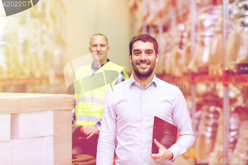 Image of businessman with clipboard  over warehouse loader