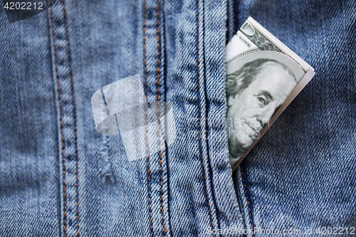 Image of dollar money in pocket of denim jacket