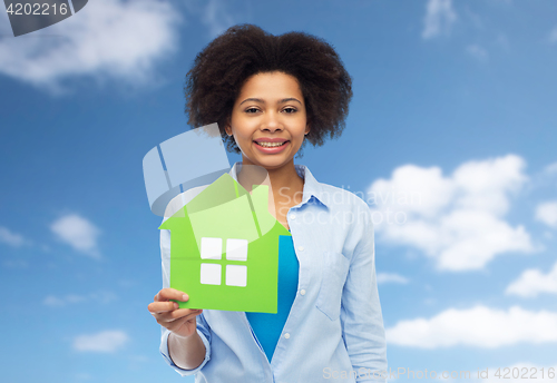 Image of happy african american woman with green house icon