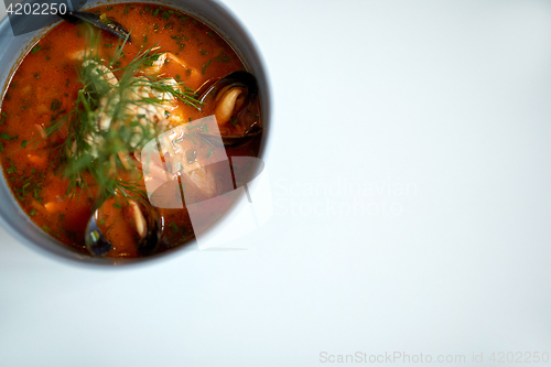 Image of seafood soup with fish and blue mussels in bowl