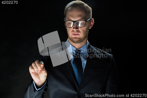 Image of close up of businessman touching virtual screen