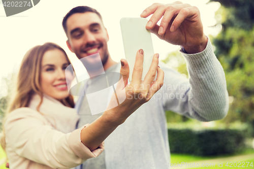 Image of close up of couple with smartphone taking selfie