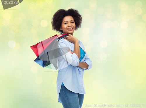 Image of smiling afro american woman with shopping bags
