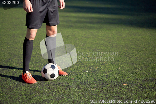 Image of soccer player playing with ball on football field