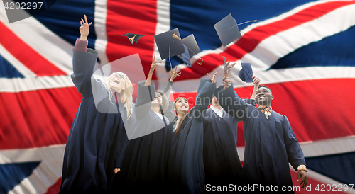 Image of happy students throwing mortarboards up