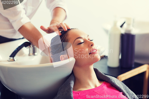 Image of happy young woman at hair salon