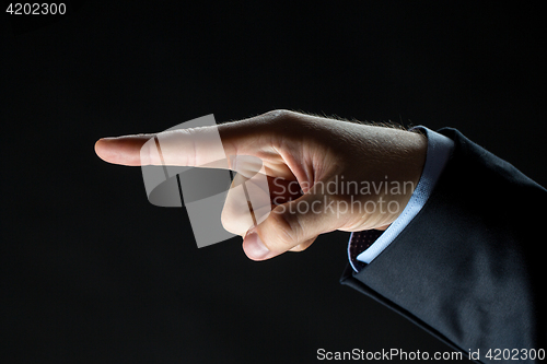 Image of close up of hand pointing finger to something