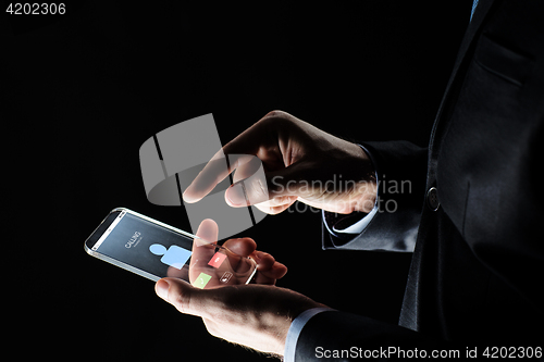 Image of close up of hands with incoming call on smartphone