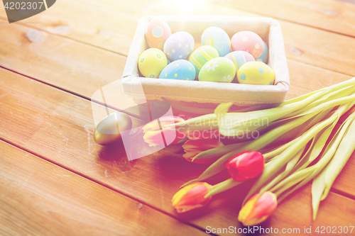 Image of close up of colored easter eggs and flowers