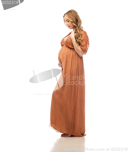 Image of happy pregnant woman touching her big belly