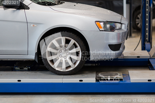Image of car on lift at repair station