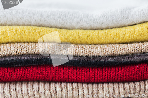 Image of close up of stacked knitted clothes