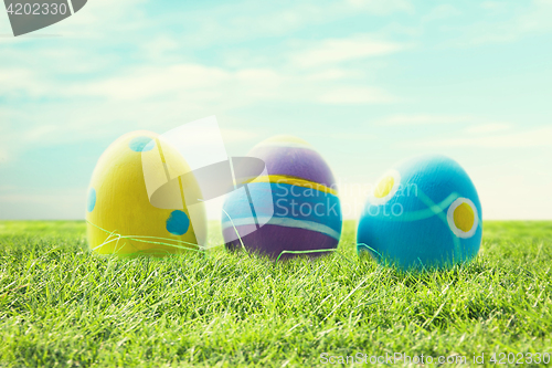 Image of close up of colored easter eggs on grass