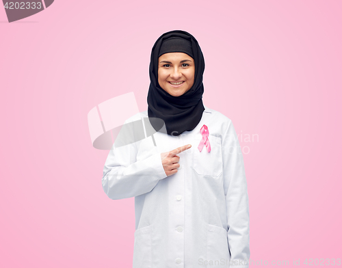 Image of muslim doctor with breast cancer awareness ribbon