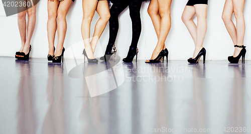 Image of diverse type pair of woman legs in hight heels black shoes isolated on white background and floor, diversity people lifestyle concept