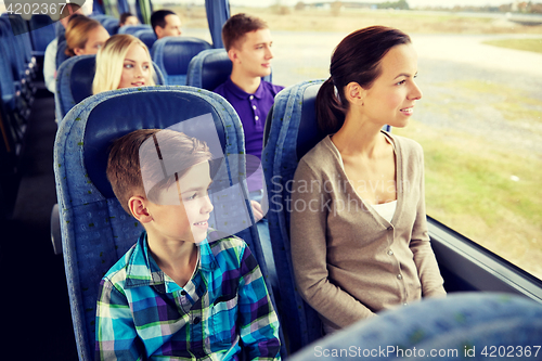 Image of happy family riding in travel bus