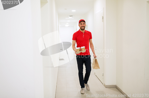 Image of man delivering coffee and food to customer home