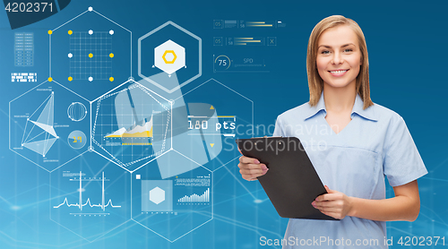 Image of smiling female doctor or nurse with clipboard