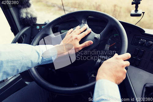 Image of close up of driver driving passenger bus