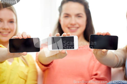 Image of happy women or teenage girls with smartphones