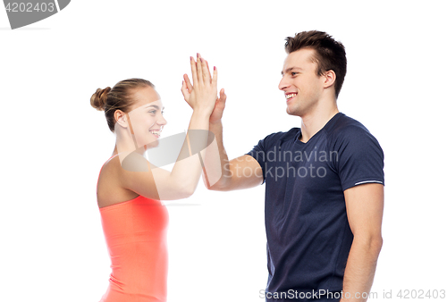 Image of happy sportive man and woman making high five