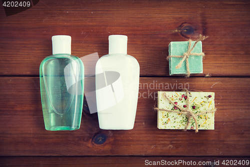 Image of close up of handmade soap bars and lotions on wood