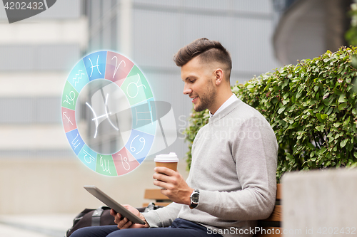 Image of man with tablet pc and coffee in city