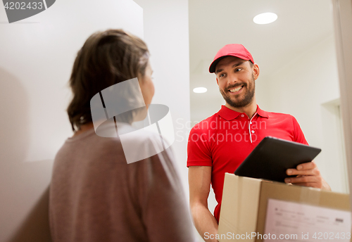 Image of deliveryman with tablet pc and box at customer